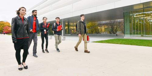 Multiple students walking on main campus